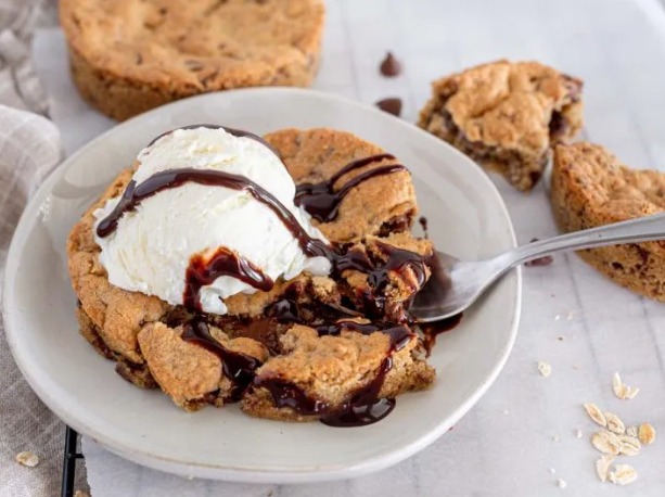 Warm deep-dish chocolate chip cookie with vanilla pod ice cream